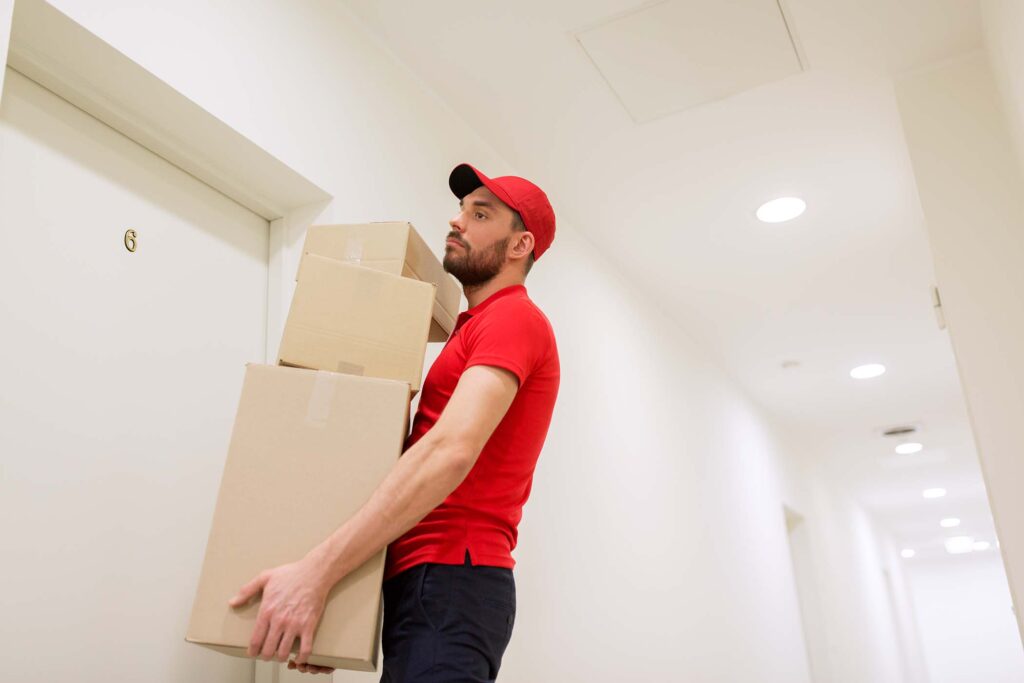 delivery-man-with-parcel-boxes-at-customer-door-P9JH3R6.jpg