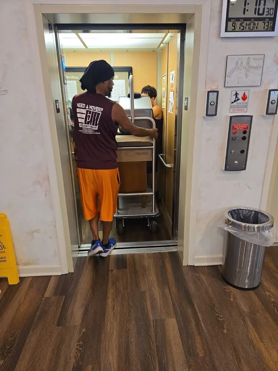 Movers in Cave Spring VA moving furniture through an apartment elevator