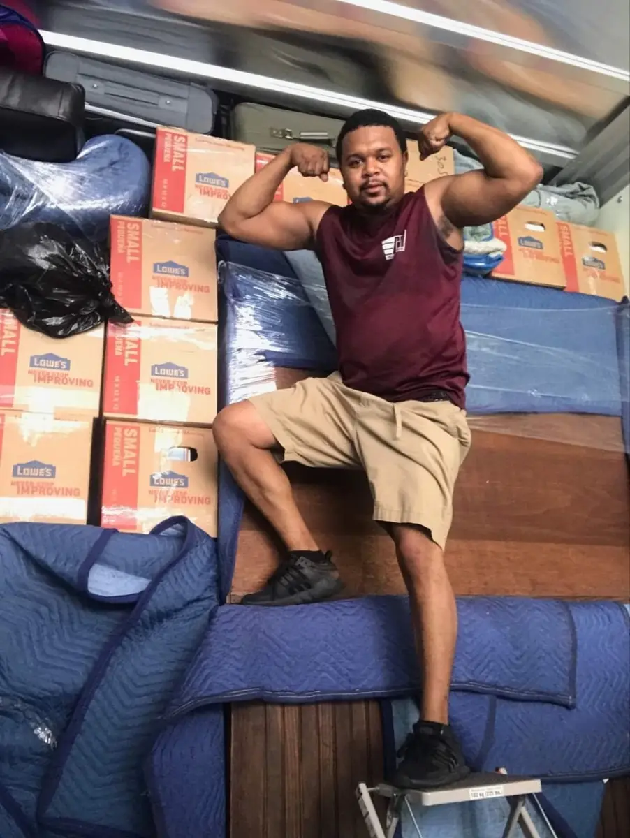 Collegiate Movers crew member inside a loaded moving truck